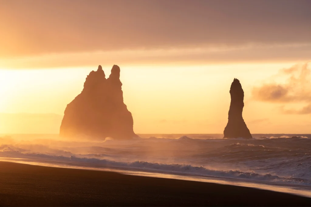 Farallones de Reynisdrangar al atardecer en la playa de Reynisfjara, Islandia